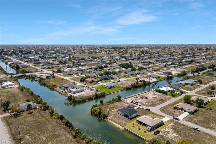 Aerial view of residential area featuring a nearby body of water