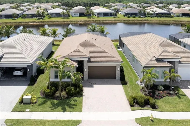 Drone / aerial view with a water view and a residential view