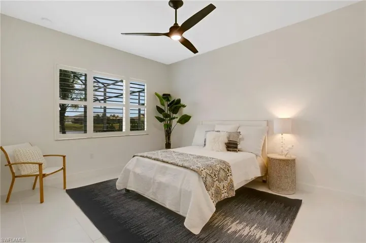 Bedroom with baseboards, a ceiling fan, and light tile patterned floors