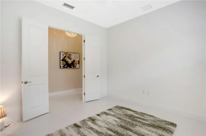 Unfurnished bedroom featuring light tile patterned floors, baseboards, and visible vents