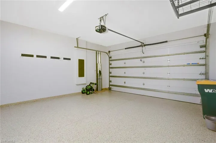 Garage featuring electric panel and a garage door opener