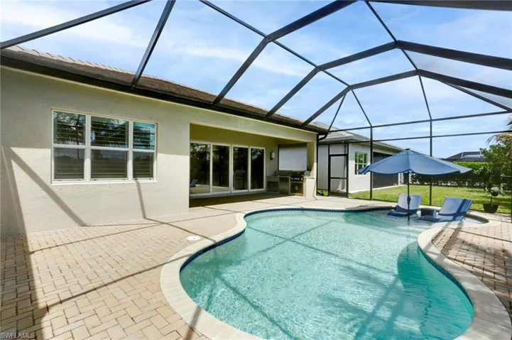Pool with a lanai and a patio area