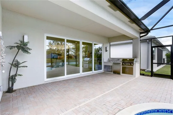 View of patio / terrace featuring area for grilling, a lanai, and a grill