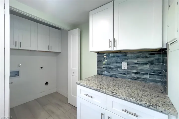 Kitchen showing laundry behind folding doors