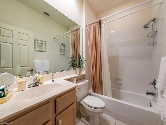 Bathroom with vanity and shower / tub combo