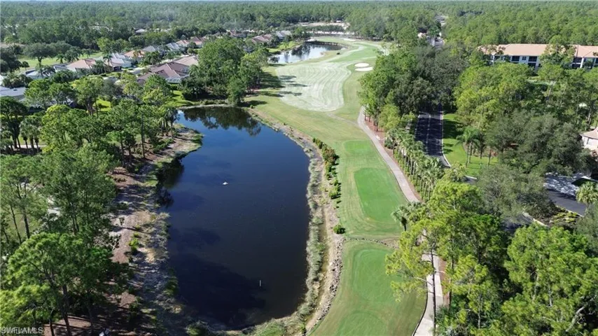 View of property location featuring a local golf course and a large body of water