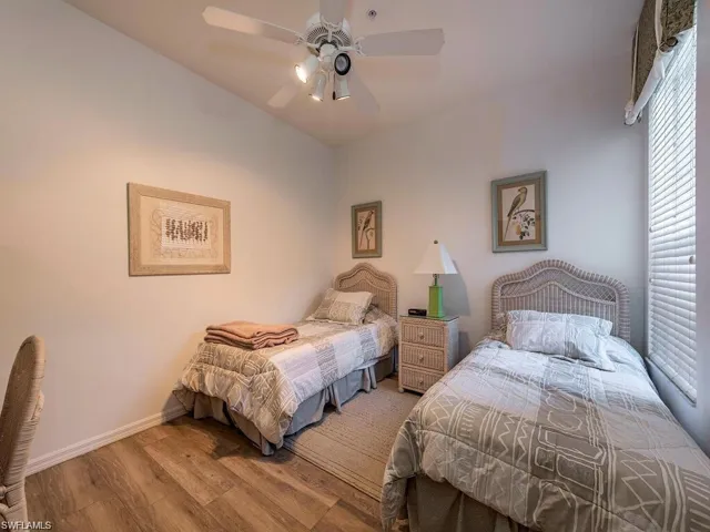 Bedroom featuring wood finished floors and a ceiling fan