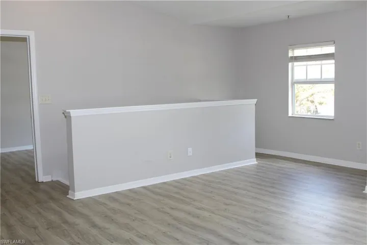 Empty room featuring baseboards and wood finished floors
