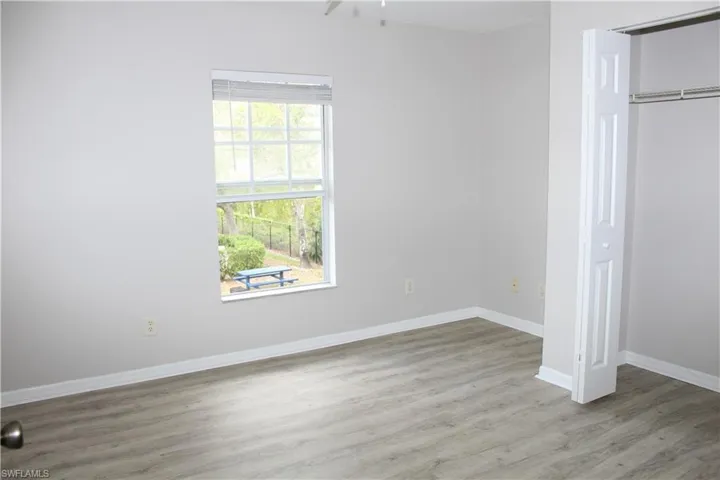 2nd Guest Bedroom Unfurnished bedroom with a closet, baseboards, and wood finished floors