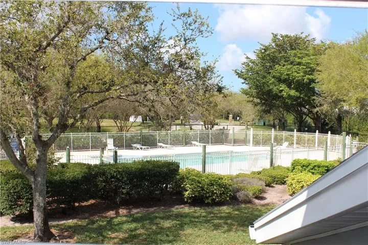 View from 2nd Floor Window, Community pool featuring fence