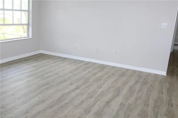 Empty room featuring baseboards and wood finished floors