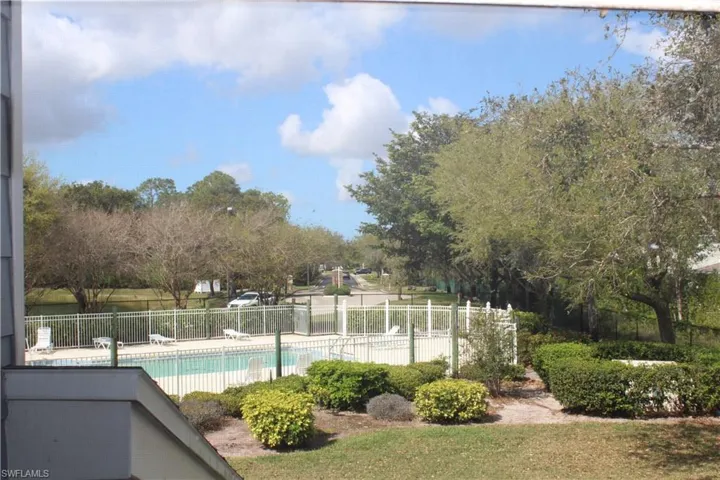 View from 2nd Floor Window, Pool with fence and a patio