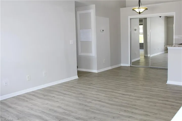 Empty room with baseboards and wood finished floors