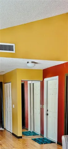 Entrance foyer featuring a textured ceiling and light wood-style flooring
