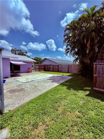 Fenced backyard with a patio