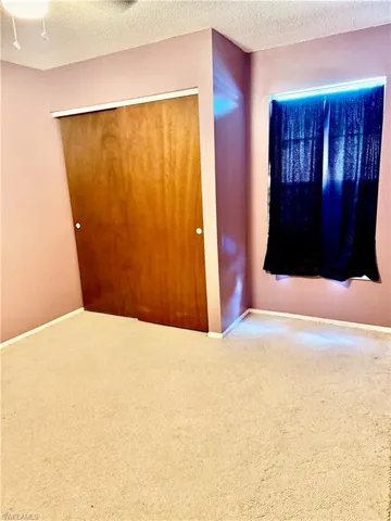 Spare room featuring a textured ceiling and carpet floors