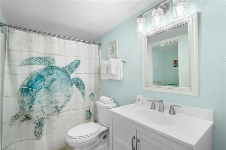 Full bathroom with vanity and curtained shower