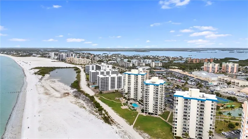 View of urban area with expansive coastline and apartment complex / building