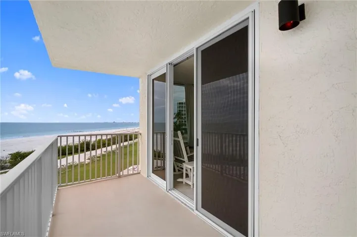 Balcony with view of water and beach