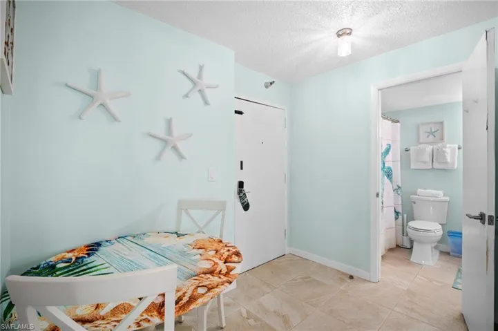 Bedroom featuring a textured ceiling and baseboards