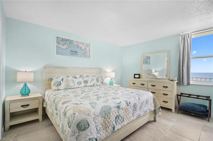 Tiled bedroom with a textured ceiling
