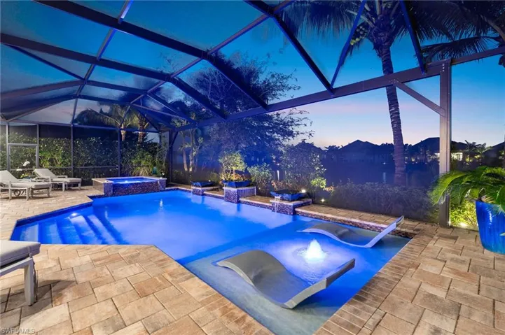 Combined pool / hot tub featuring a lanai, a patio, and a sunroom