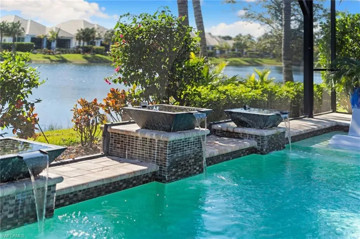 Swimming pool featuring a patio area and a water view