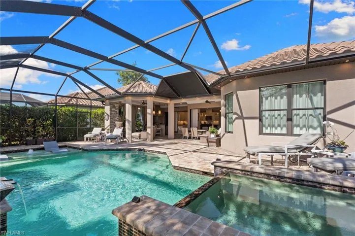Combined pool / hot tub with a patio, a sunroom, and a lanai