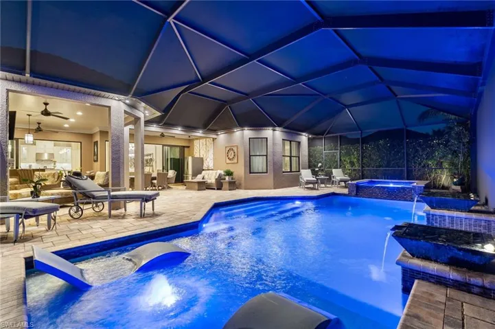 Integrated pool / spa featuring an outdoor living / dining area, a sunroom, glass enclosure, and a patio