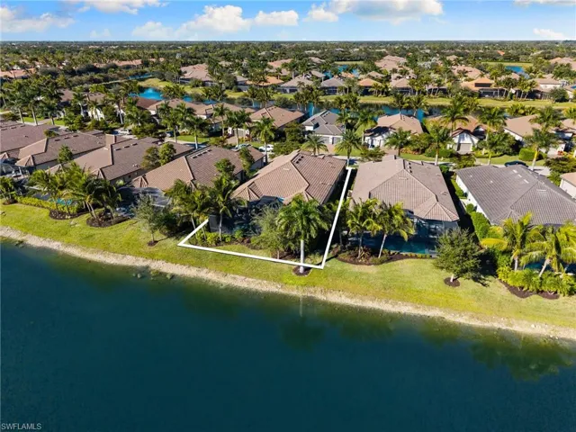 Aerial perspective of suburban area featuring a large body of water