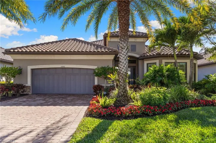Mediterranean / spanish home with a tile roof, decorative driveway, stucco siding, and a garage