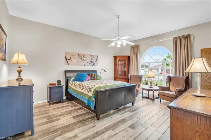 Bedroom with hardwood / wood-style flooring and ceiling fan