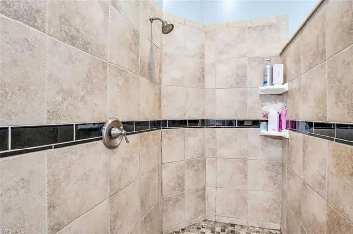 Interior details featuring a tile shower