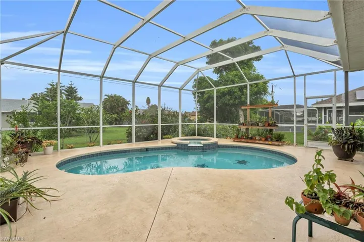 View of swimming pool featuring an in ground hot tub, a patio, and glass enclosure