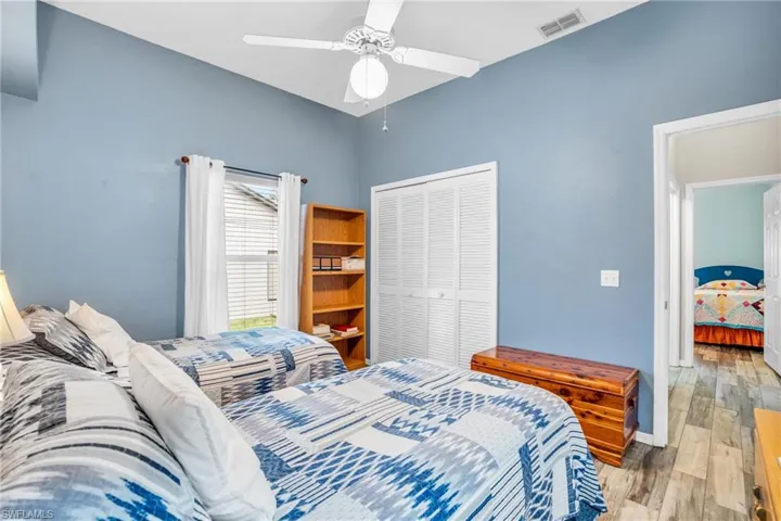 Bedroom featuring light hardwood / wood-style flooring, a closet, and ceiling fan