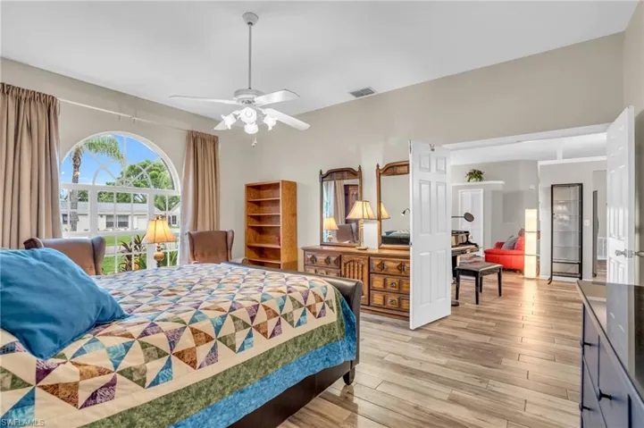 Bedroom with ceiling fan and wood-type flooring