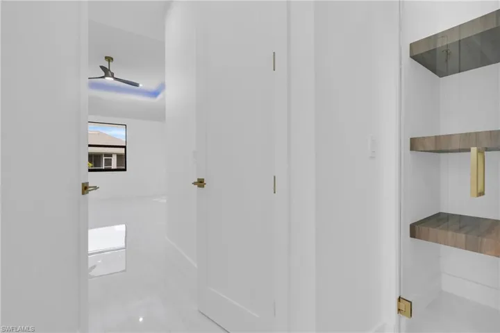 Bathroom with tile patterned floors and ceiling fan