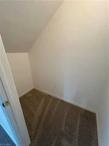 Walk in closet featuring vaulted ceiling