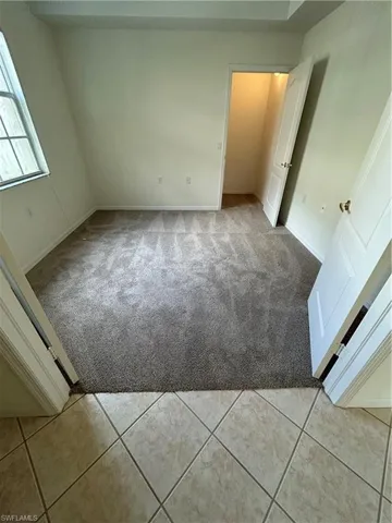 Unfurnished bedroom with light carpet