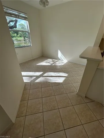 With light tile patterned floors and baseboards