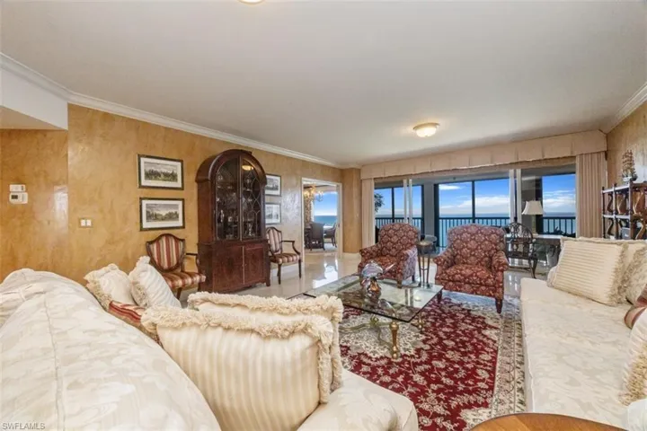Living room featuring ornamental molding and a water view