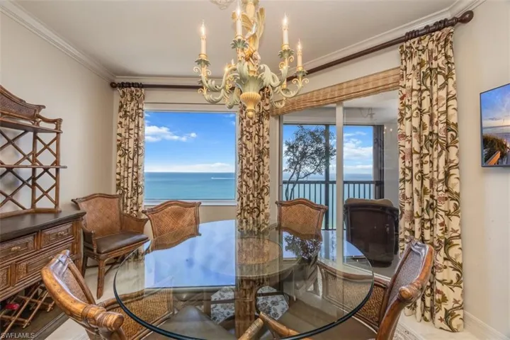 Dining room featuring ornamental molding, a chandelier, and healthy amount of natural light