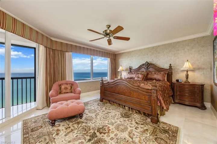 Bedroom with crown molding, a water view, wallpapered walls, access to exterior, and ceiling fan