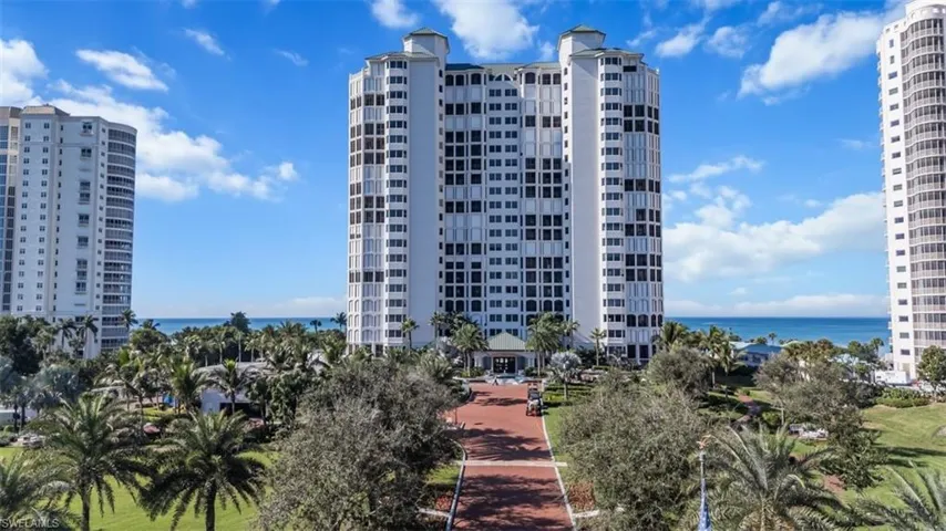 View of apartment building / complex featuring a water view