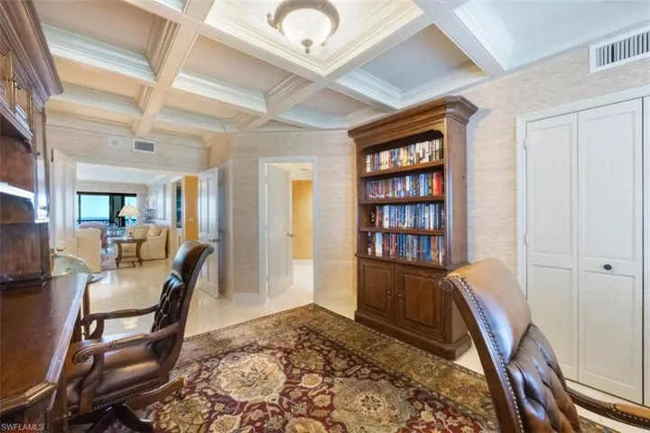 Office area featuring coffered ceiling, beam ceiling, and ornamental molding