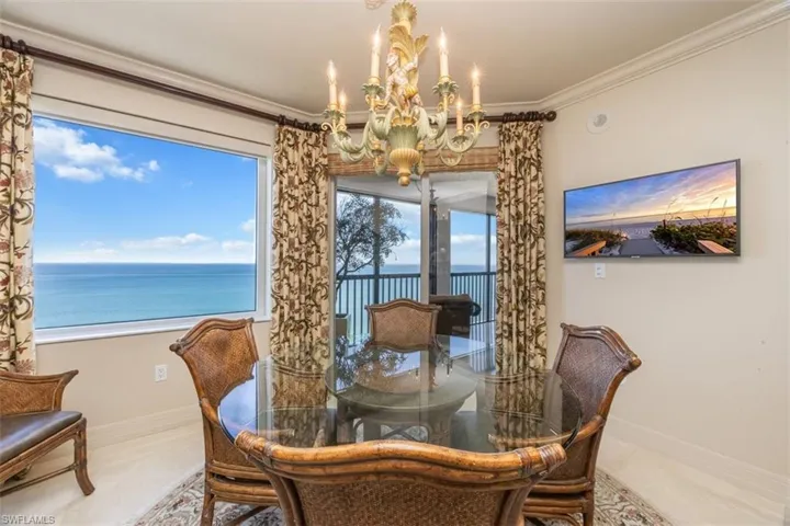 Dining area featuring crown molding and a chandelier