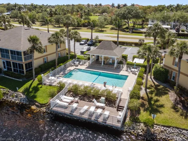 Pool with a patio area and fence