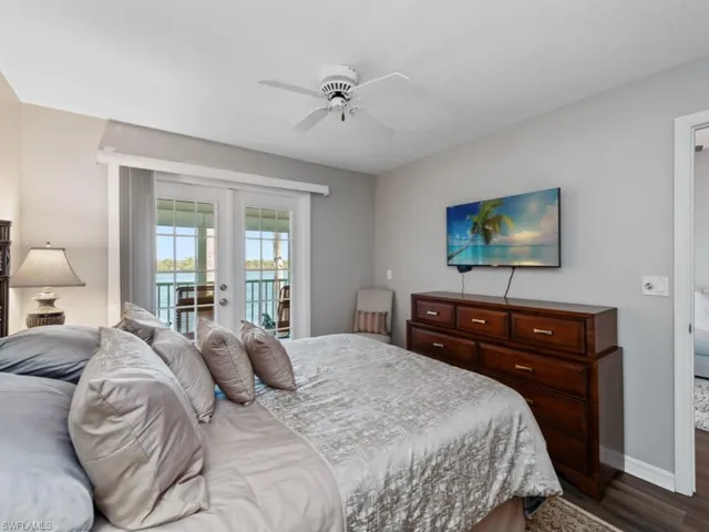 Bedroom with access to exterior, ceiling fan, baseboards, and dark wood-style floors