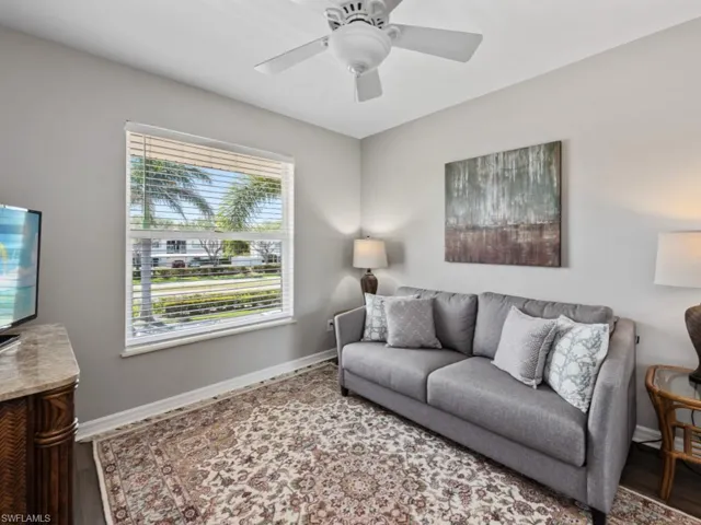 Living room with wood finished floors, baseboards, and a ceiling fan