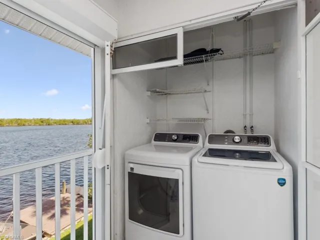 Washroom with a water view, independent washer and dryer, a wealth of natural light, and laundry area